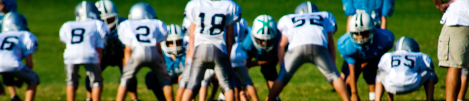 Group of football players facing off